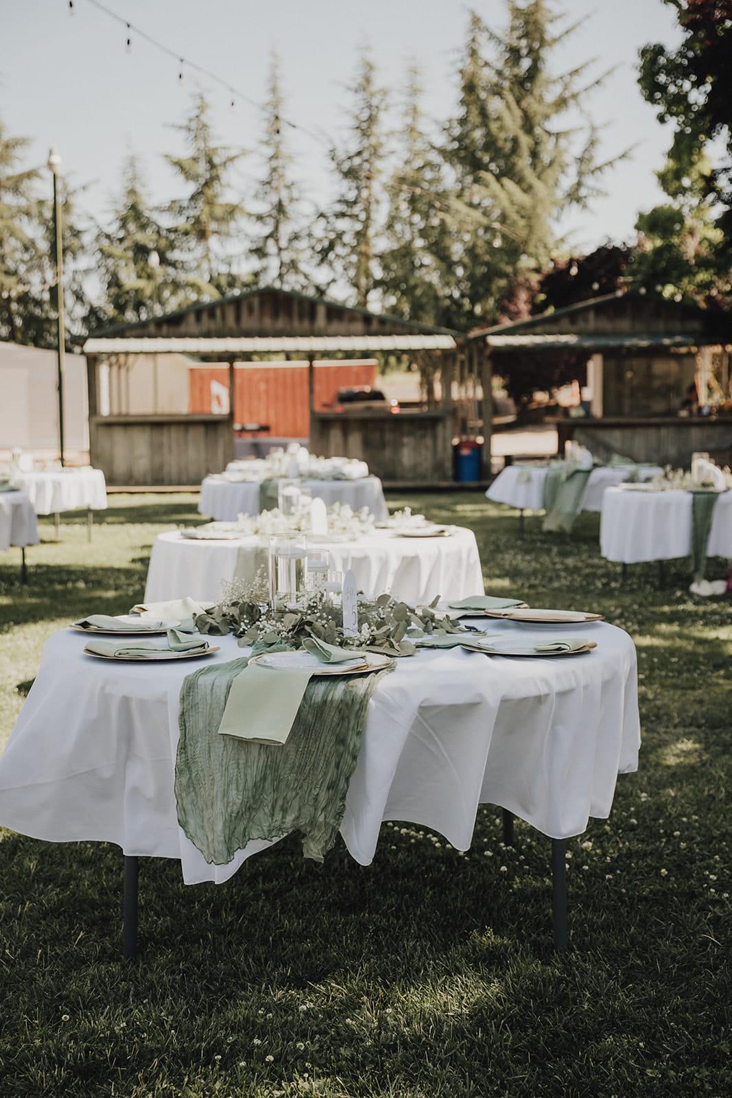 Reception tables set with sage runners and eucalyptus