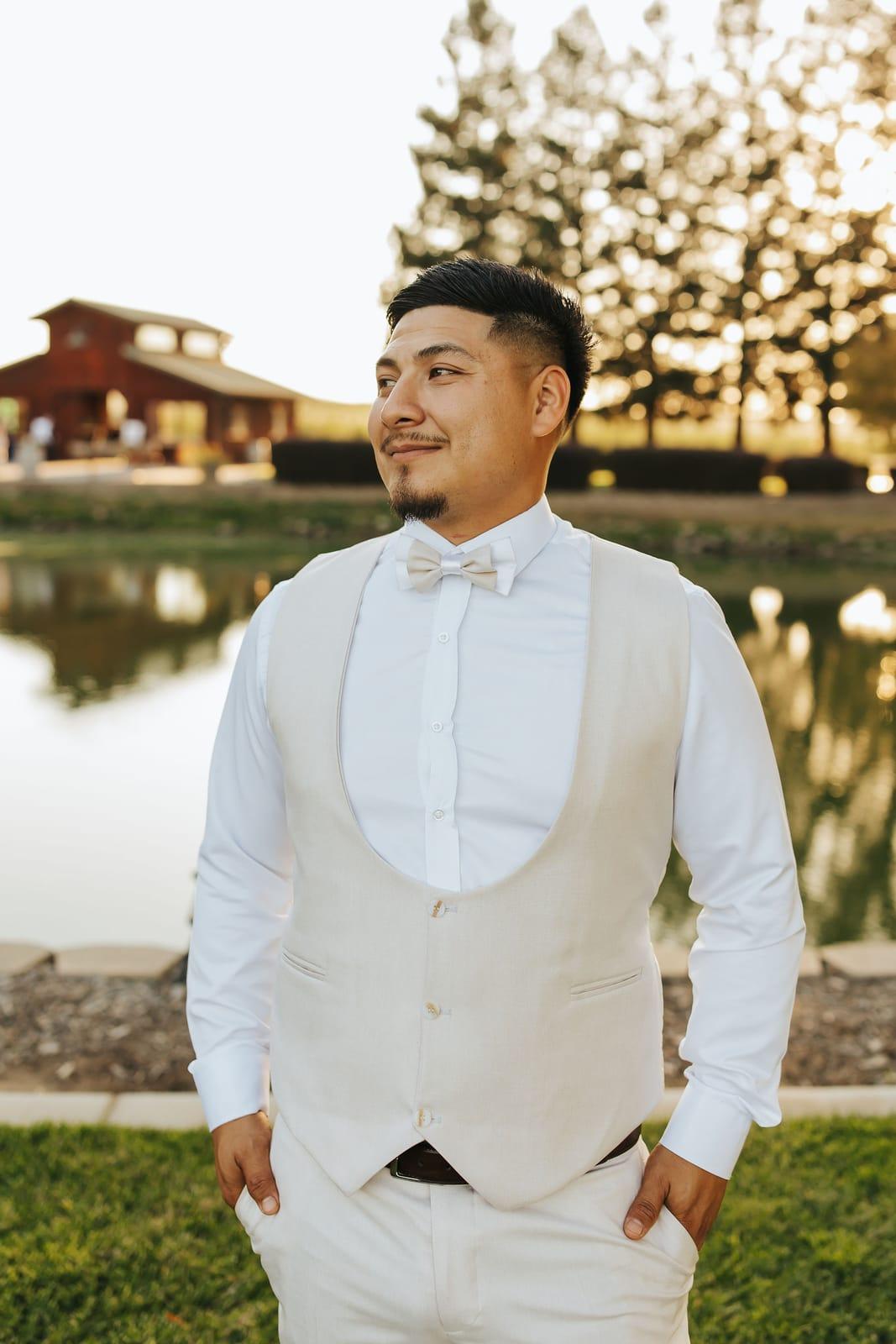 The groom by the water, the red barn across the pond