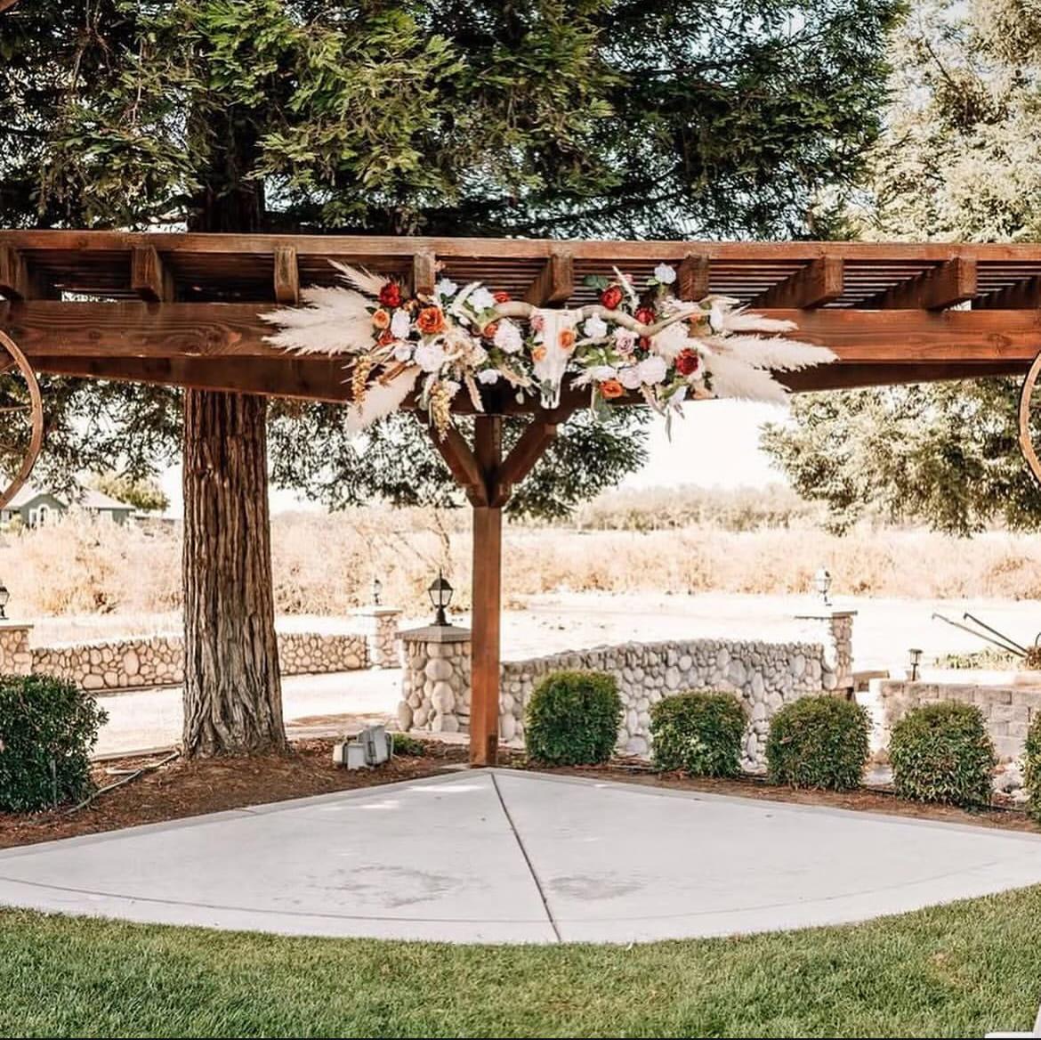 Florals and pampas draped across the timber pergola above the dance floor